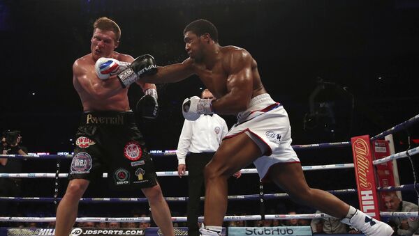 Britain's Anthony Joshua, right, lands a blow on Alexander Povetkin on his way to retaining his WBA, IBF, and WBO heavyweight boxing titles, Saturday, Sept. 22, 2018, at Wembley Stadium in London. - Sputnik International