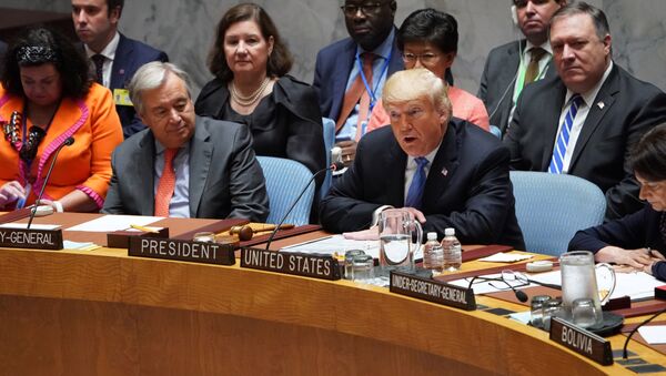 UN General Secretary Antonio Guterres listens as US President Donald Trump (C) opens the UN Security Council meeting on September 26, 2018 in New York on the sidelines of the UN General Assembly - Sputnik International
