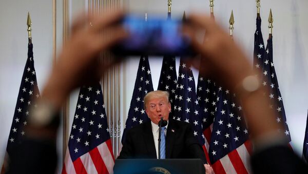 A reporter uses his mobile phone to record U.S. President Donald Trump at a news conference on the sidelines of the 73rd session of the United Nations General Assembly in New York, U.S., September 26, 2018 - Sputnik International