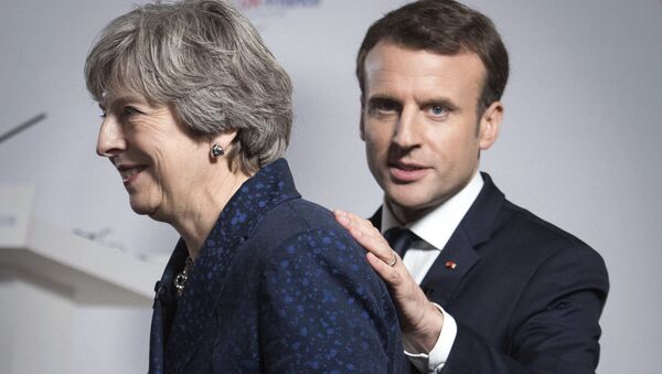 Britain's Prime Minister Theresa May and French President Emmanuel Macron during a media conference at the Royal Military Academy Sandhurst, in Camberley, England, after UK-France summit talks, Thursday Jan. 18, 2018. - Sputnik International