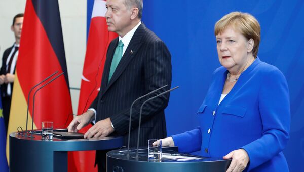 German Chancellor Angela Merkel and Turkish President Tayyip Erdogan address a news conference at the chancellery in Berlin, Germany, September 28, 2018 - Sputnik International