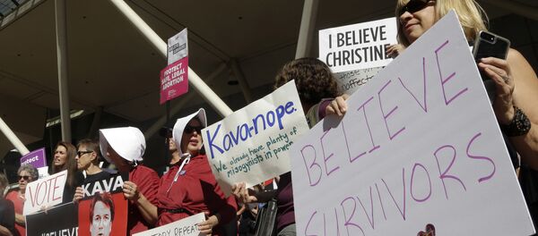 Protestors hold signs during a demonstration against the nomination of Brett Kavanaugh to sit on the U.S. Supreme Court in Portland, Ore., Friday, Sept. 28, 2018 - Sputnik International