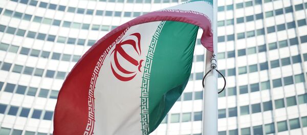 An Iranian flag waves in a wind outside the Vienna International Centre hosting the United Nations (UN) headquarters and the International Atomic Energy Agency (IAEA) as the socalled EU 5+1 talks with Iran take place in Vienna, on July 3, 2014. - Sputnik International