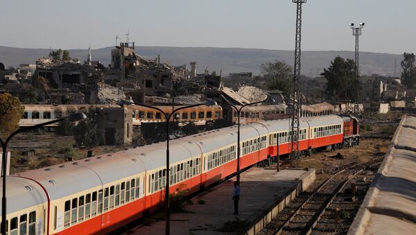 Damaged buildings are seen next a railway station in Damascus - Sputnik International