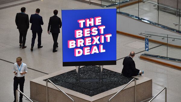 Delegates are seen near a sign that reads The Best Brexit Deal at the venue on the first day of the Conservative Party Conference 2018 at the International Convention Centre in Birmingham, on September 30, 2018. - Sputnik International