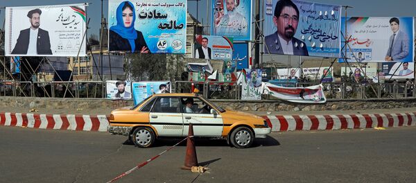 A vehicle drives in front of election posters of parliamentarian candidates installed during the first day of elections campaign in Kabul, Afghanistan September 28, 2018 - Sputnik International