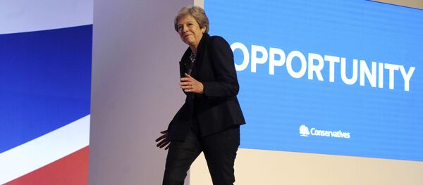 Conservative Party Leader and Prime Minister Theresa May dances as she arrives on stage to address delegates during a speech at the Conservative Party Conference at the ICC, in Birmingham, England, Wednesday, Oct. 3 , 2018. - Sputnik International