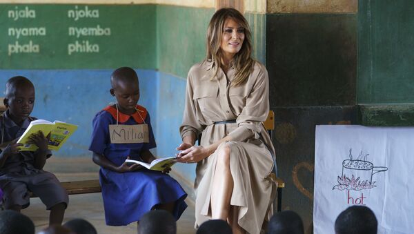 First lady Melania Trump helps a student as she visits a language class at Chipala Primary School, in Lilongwe, Malawi, Thursday, Oct. 4, 2018. Mrs. Trump is visiting Africa on her first big solo international trip, aiming to make child well-being the focus of a five-day, four-country tour. - Sputnik International