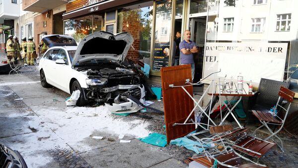 Firefighters look at damage after a man drove a car into a cafe in the Charlottenburg district of Berlin, Germany, October 5, 2018, injuring several people - Sputnik International
