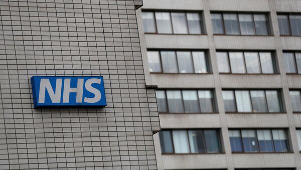 FILE PHOTO: NHS sign is seen at St Thomas' Hospital in central London - Sputnik International