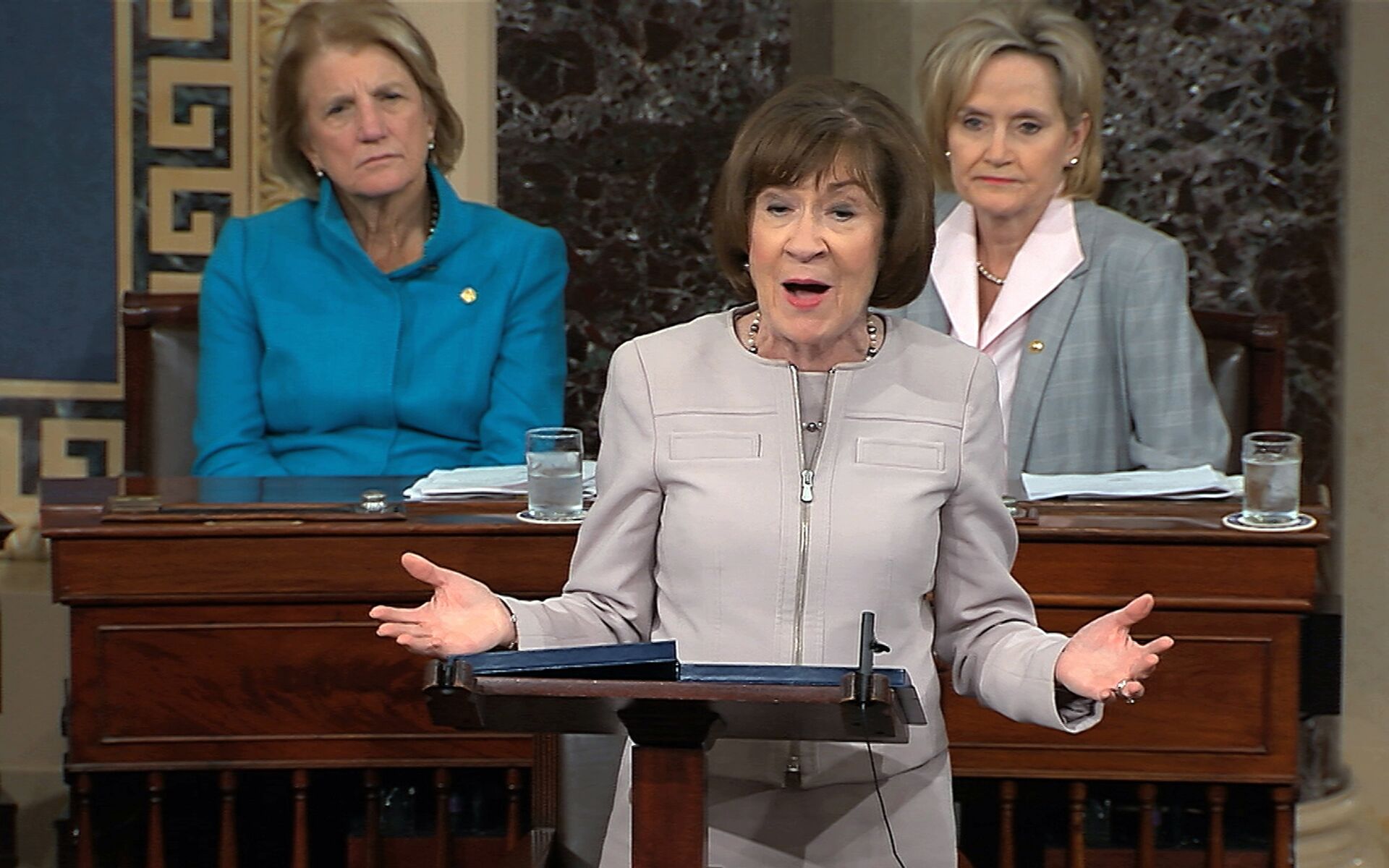 Sen. Susan Collins, R-Maine., speaks on the Senate floor about her vote on Supreme Court nominee Judge Brett Kananaugh, Friday, Oct. 5, 2018 in the Capitol in Washington. Sen Shelly Capito, R-W.Va., sits rear left and Sen. Cindy Hyde-Smith, R-Miss., sits right. (Senate TV via AP) - Sputnik International, 1920, 19.09.2024