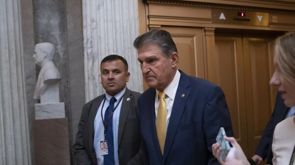 Sen. Joe Manchin, D-W.Va., arrives at the chamber for a procedural vote to advance the confirmation of Supreme Court nominee Brett Kavanaugh, at the Capitol in Washington, Friday, Oct. 5, 2018.  - Sputnik International