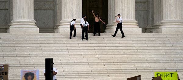 A topless woman is detained by Supreme Court Police after the Senate confirmed the nomination of Judge Brett Kavanaugh in Washington, U.S., October 6, 2018 A topless woman is detained by Supreme Court Police after the Senate confirmed the nomination of Judge Brett Kavanaugh in Washington, U.S., October 6, 2018 - Sputnik International