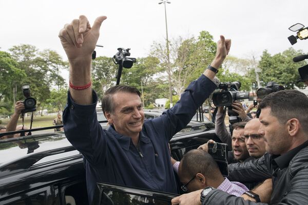 Presidential frontrunner Jair Bolsonaro, of the Social Liberal Party, flashes thumbs up to supporters after voting at a polling station in Rio de Janeiro, Brazil, Sunday, Oct. 7, 2018. - Sputnik International