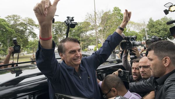 Presidential frontrunner Jair Bolsonaro, of the Social Liberal Party, flashes thumbs up to supporters after voting at a polling station in Rio de Janeiro, Brazil, Sunday, Oct. 7, 2018. - Sputnik International
