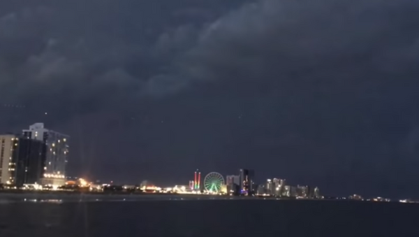 Footage uploaded on website Mutual UFO Network shows mysterious lights hovering above popular US beach resort - Sputnik International