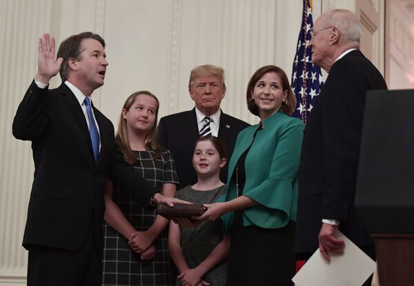 President Donald Trump, center, listens as retired Supreme Court Justice Anthony Kennedy, right, ceremonially swears-in Supreme Court Justice Brett Kavanaugh, left, in the East Room of the White House in Washington, Monday, Oct. 8, 2018. Kavanaugh's wife Ashley watches, second from right with daughters Margaret, left, and Liza. - Sputnik International
