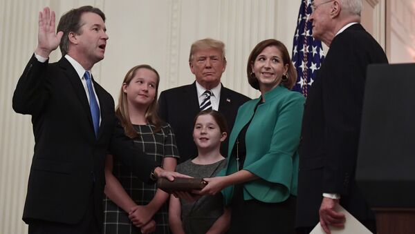 President Donald Trump, center, listens as retired Supreme Court Justice Anthony Kennedy, right, ceremonially swears-in Supreme Court Justice Brett Kavanaugh, left, in the East Room of the White House in Washington, Monday, Oct. 8, 2018. Kavanaugh's wife Ashley watches, second from right with daughters Margaret, left, and Liza. - Sputnik International