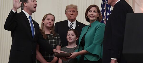 President Donald Trump, center, listens as retired Supreme Court Justice Anthony Kennedy, right, ceremonially swears-in Supreme Court Justice Brett Kavanaugh, left, in the East Room of the White House in Washington, Monday, Oct. 8, 2018. Kavanaugh's wife Ashley watches, second from right with daughters Margaret, left, and Liza. President Donald Trump, center, listens as retired Supreme Court Justice Anthony Kennedy, right, ceremonially swears-in Supreme Court Justice Brett Kavanaugh, left, in the East Room of the White House in Washington, Monday, Oct. 8, 2018. Kavanaugh's wife Ashley watches, second from right with daughters Margaret, left, and Liza. - Sputnik International