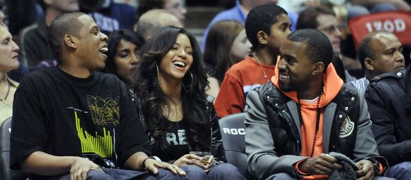 Entertainers Jay-Z, left, Beyonce and Kanye West, right, laugh during the New Jersey Nets' NBA basketball game against the Seattle SuperSonics on Wednesday night, Jan. 9, 2008, in East Rutherford, N.J. - Sputnik International