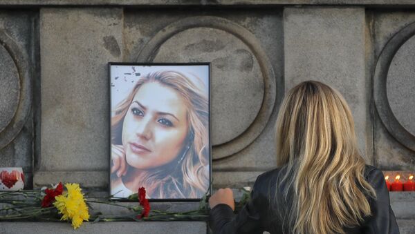 A woman places flowers next to a portrait of slain television reporter Viktoria Marinova during a vigil at the Liberty Monument in Ruse, Bulgaria, Monday, Oct. 8, 2018 A woman places flowers next to a portrait of slain television reporter Viktoria Marinova during a vigil at the Liberty Monument in Ruse, Bulgaria, Monday, Oct. 8, 2018 - Sputnik International