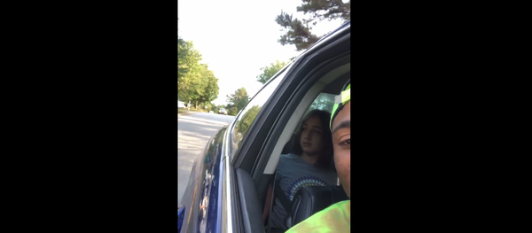 Corey Lewis records a Facebook Live video of an unidentified woman following him for babysitting two white kids. 10-year-old Addison can be seen in the back seat of the car. Corey Lewis records a Facebook Live video of an unidentified woman following him for babysitting two white kids. 10-year-old Addison can be seen in the back seat of the car. - Sputnik International