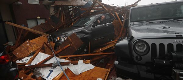 A storm chaser climbs into his vehicle during the eye of Hurricane Michael to retrieve equipment after a hotel canopy collapsed in Panama City Beach, Fla., Wednesday, Oct. 10, 2018 - Sputnik International
