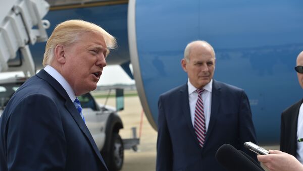 US President Donald Trump speaks to the press before making his way to board Air Force One on May 4, 2018 at Andrews Air Force Base, Maryland as he heads to Dallas, Texas to address the National Rifle Association Leadership Forum. Shown (C) is White House Chief of Staff John Kelly. - Sputnik International