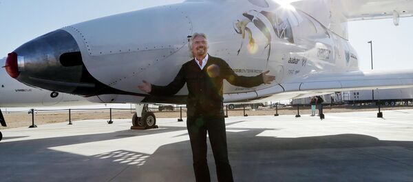 British entrepreneur Richard Branson poses with SpaceShipTwo at a Virgin Galactic hangar at Mojave Air and Space Port in Mojave, Calif. - Sputnik International