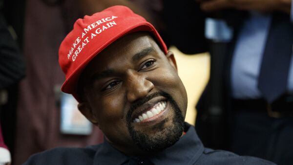 Rapper Kanye West smiles as he listens to a question from a reporter during a meeting in the Oval Office of the White House with President Donald Trump, Thursday, Oct. 11, 2018, in Washington. - Sputnik International
