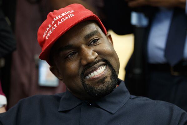Rapper Kanye West smiles as he listens to a question from a reporter during a meeting in the Oval Office of the White House with President Donald Trump, Thursday, Oct. 11, 2018, in Washington.  - Sputnik International