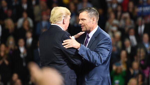 US President Donald Trump (L) greets Kansas gubernatorial candidate Kris Kobach during a Make America Great Again rally in Topeka, Kansas, on October 6, 2018. - Sputnik International