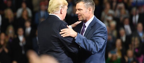 US President Donald Trump (L) greets Kansas gubernatorial candidate Kris Kobach during a Make America Great Again rally in Topeka, Kansas, on October 6, 2018. - Sputnik International