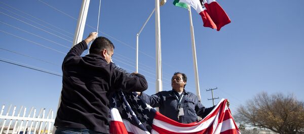 In this Friday, Dec. 27, 2013 photo, workers at one of maquiladoras of the TECMA group prepare to raise the U.S. flag along with the Mexican and TECMA flags in Ciudad Juarez, Mexico - Sputnik International