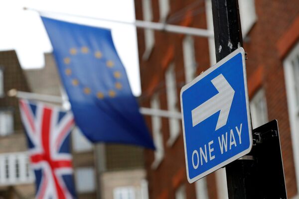 A traffic sign is seen in front of European and Union flags in London, Britain - Sputnik International