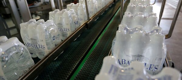 Plastic bottles of mineral water on the bottling line Plastic bottles of mineral water on the bottling line - Sputnik International