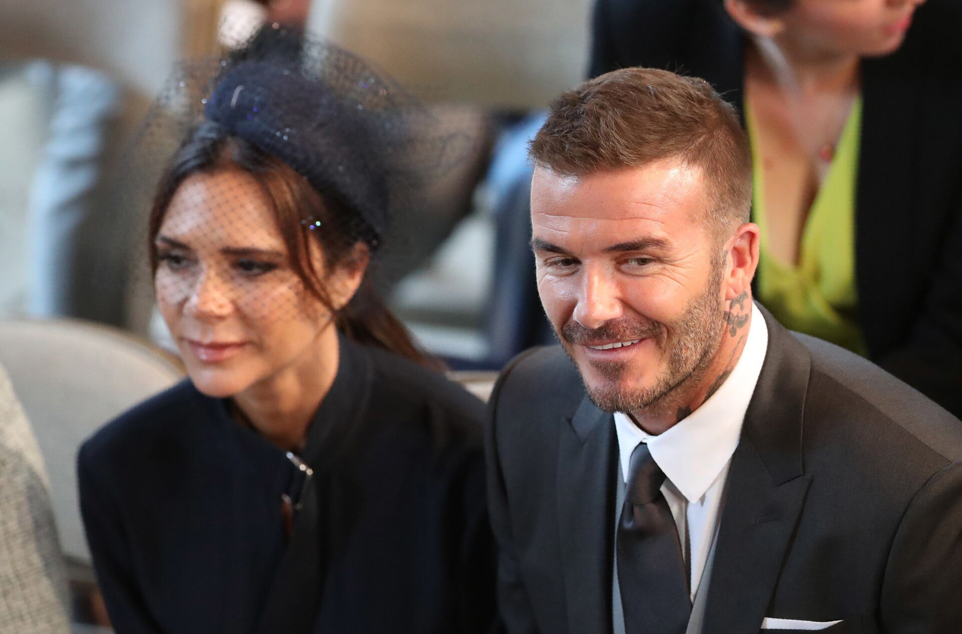 David and Victoria Beckham take their seats in St George's Chapel before the wedding ceremony of Britain's Prince Harry, Duke of Sussex and US actress Meghan Markle in St George's Chapel, Windsor Castle, in Windsor, on May 19, 2018.  - Sputnik International, 1920, 31.10.2021