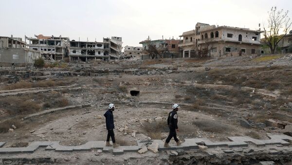 Members of the Civil Defence, also known as the 'White Helmets', are seen inspecting the damage at a Roman ruin site in Daraa, Syria (File) - Sputnik International