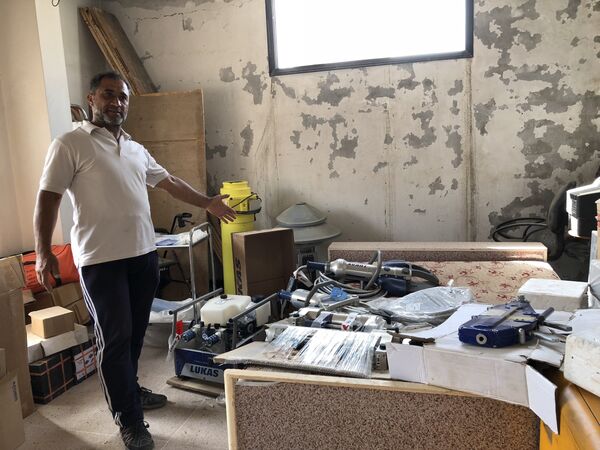 Hassan showing some of the equipment brought from Jordan used by the local White Helmets. Hassan showing some of the equipment brought from Jordan used by the local White Helmets. - Sputnik International