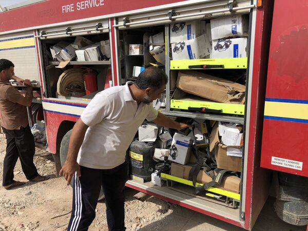 Hassan showing some of the rescue equipment in the local fire engine's compartments. Hassan showing some of the rescue equipment in the local fire engine's compartments. - Sputnik International