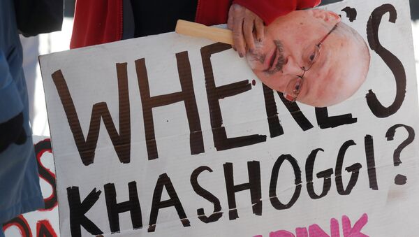 An activist holds a sign and image of missing Saudi journalist Jamal Khashoggi during a demonstration calling for sanctions against Saudi Arabia and to protest Khashoggi's disappearance, outside the White House in Washington, U.S., October 19, 2018 - Sputnik International