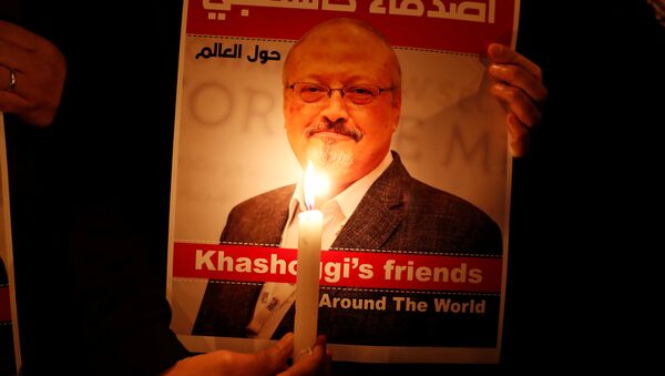 A demonstrator holds a poster with a picture of Saudi journalist Jamal Khashoggi - Sputnik International