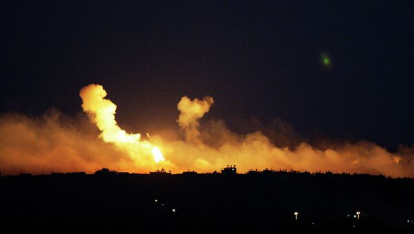 The sky is illuminated by explosions from Israeli military operations over the outskirts of Gaza City as seen from the Israel-Gaza Border. FILE PHOTO - Sputnik International