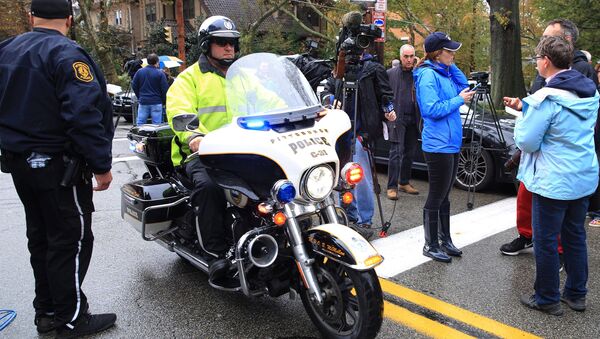 A police officer on motorcycle passes through a roadblock as he responds after a gunman opened fire at the Tree of Life synagogue in Pittsburgh. - Sputnik International