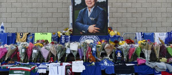 A portrait of Leicester City Football Club's Thai chairman Vichai Srivaddhanaprabha, who died in a helicopter crash at the club's stadium, is seen amid flowers and tributes outside the King Power Stadium in Leicester, eastern England, on October 29, 2018 - Sputnik International