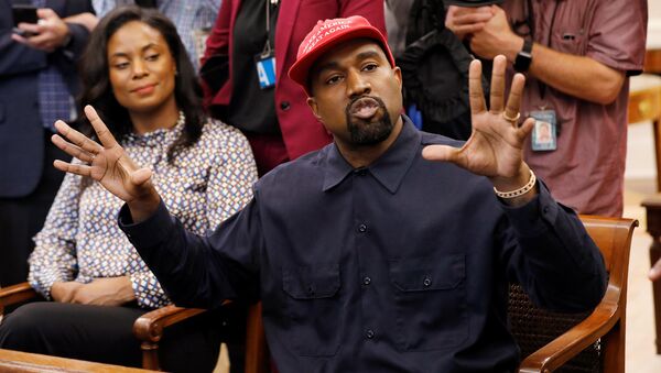 Rapper Kanye West speaks as he sits next to Monique Brown (L), wife of NFL Hall of Fame player Jim Brown, during a meeting with U.S. President Donald Trump in the Oval Office at the White House in Washington, U.S., October 11, 2018 - Sputnik International