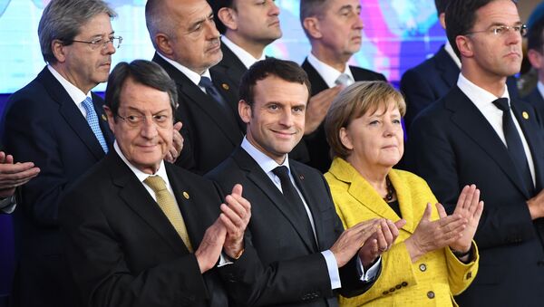 Germany's Chancellor Angela Merkel (2R), France's President Emmanuel Macron (2L), Netherland's Prime minister Mark Rutte (R) and Cyprus' President Nicos Anastasiades (1st-L) attend a ceremony on the Permanent Structure Cooperation (PESCO) on the margin of the first day of a European union summit in Brussels on December 14, 2017. - Sputnik International