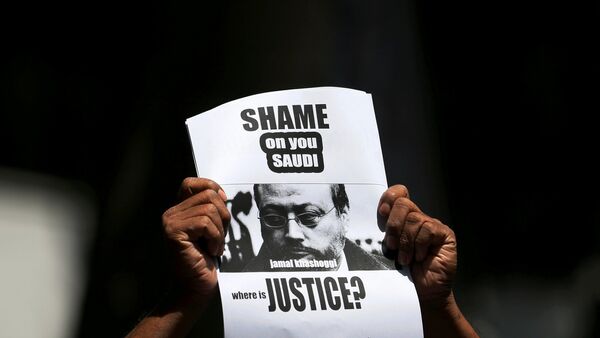 A member of Sri Lankan web journalist association holds a placard during a protest condemning the murder of slain journalist Jamal Khashoggi in front of the Saudi Embassy in Colombo, Sri Lanka October 25, 2018 - Sputnik International