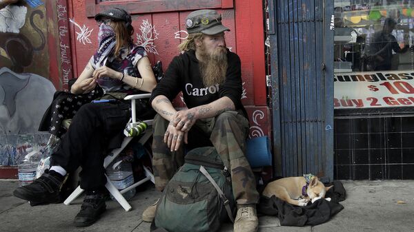 In this Oct. 1, 2018 photo, Stormy Nichole Day, left, sits on a sidewalk on Haight Street with Nord (last name not given) and his dog Hobo while interviewed about being homeless in San Francisco - Sputnik International