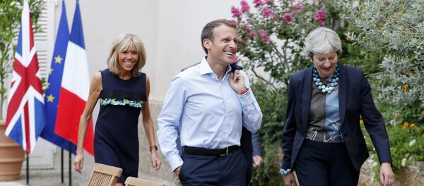 French President Emmanuel Macron and his wife Brigitte Macron, left, walk with British Prime Minister Theresa May, right, and her husband Philip May, hidden, prior to a diner at the Fort de Bregancon in Bornes-les-Mimosas, southern France, Friday Aug. 3, 2018 French President Emmanuel Macron and his wife Brigitte Macron, left, walk with British Prime Minister Theresa May, right, and her husband Philip May, hidden, prior to a diner at the Fort de Bregancon in Bornes-les-Mimosas, southern France, Friday Aug. 3, 2018 - Sputnik International